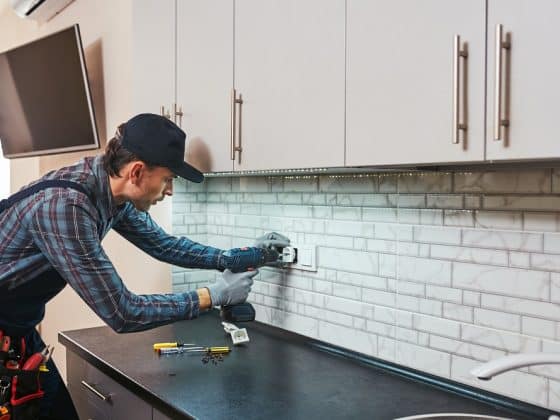 electricity protection. side view of young handyman with perforator